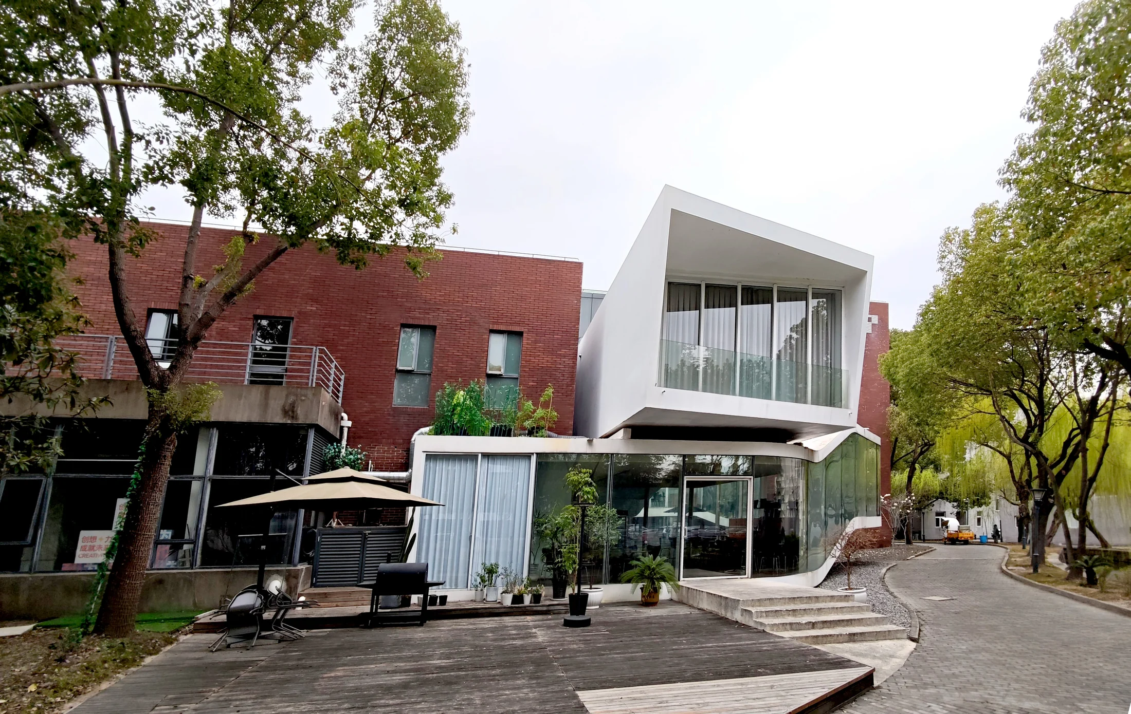 The entrance and projecting upper room connect the clubhouse to the existing brick buildings.