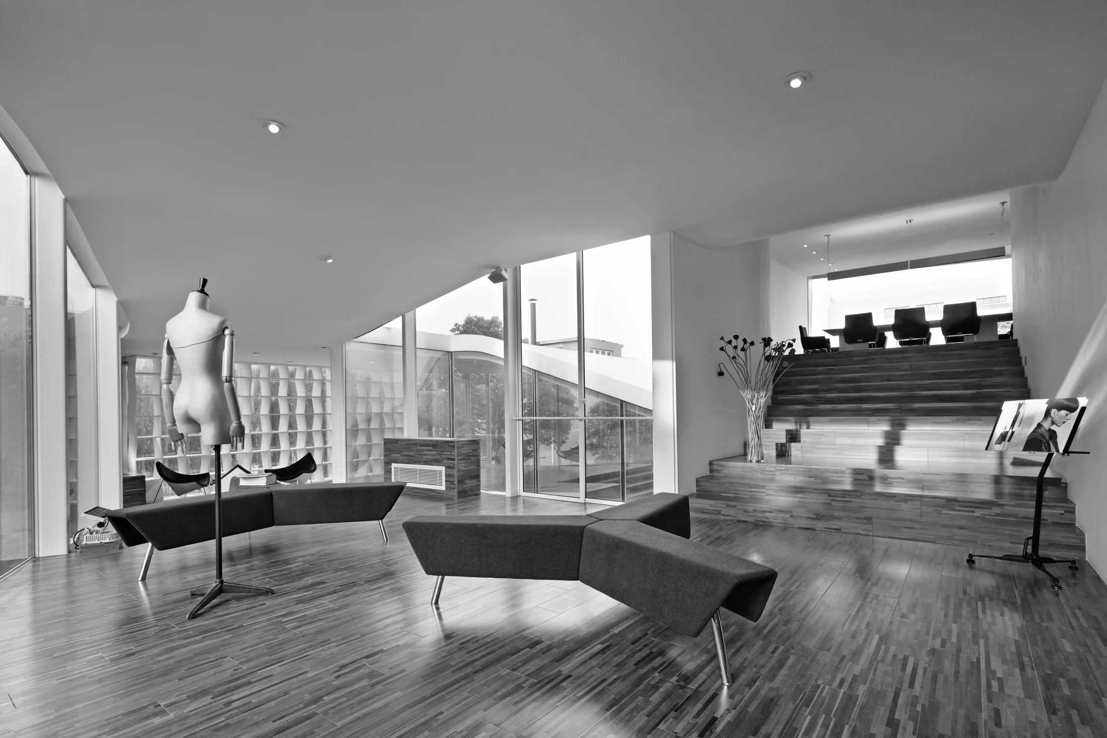 Broad timber steps connect the reception lounge to the raised reading area.