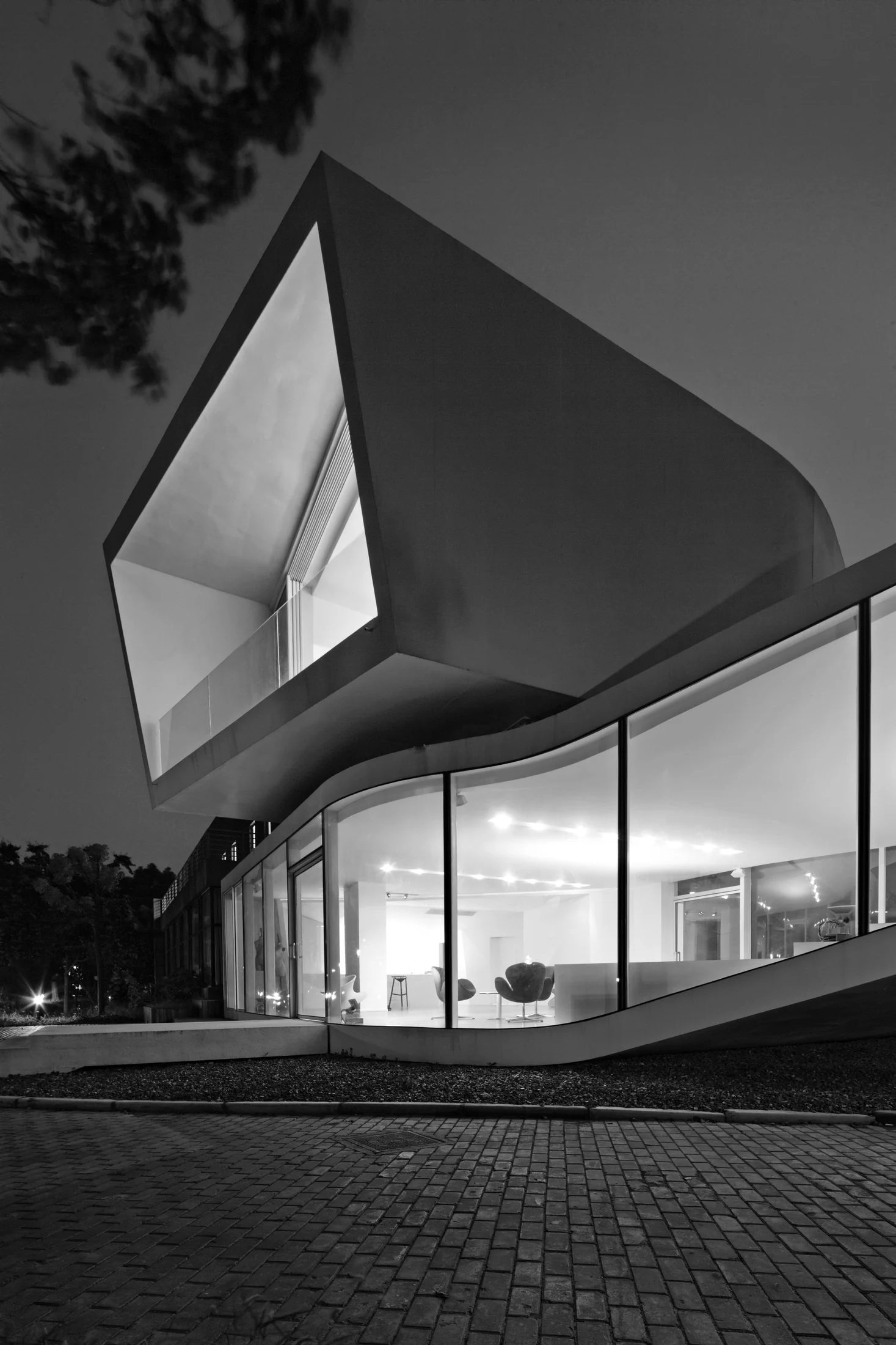 The upper room is framed by a deep white perimeter above the illuminated ground level.