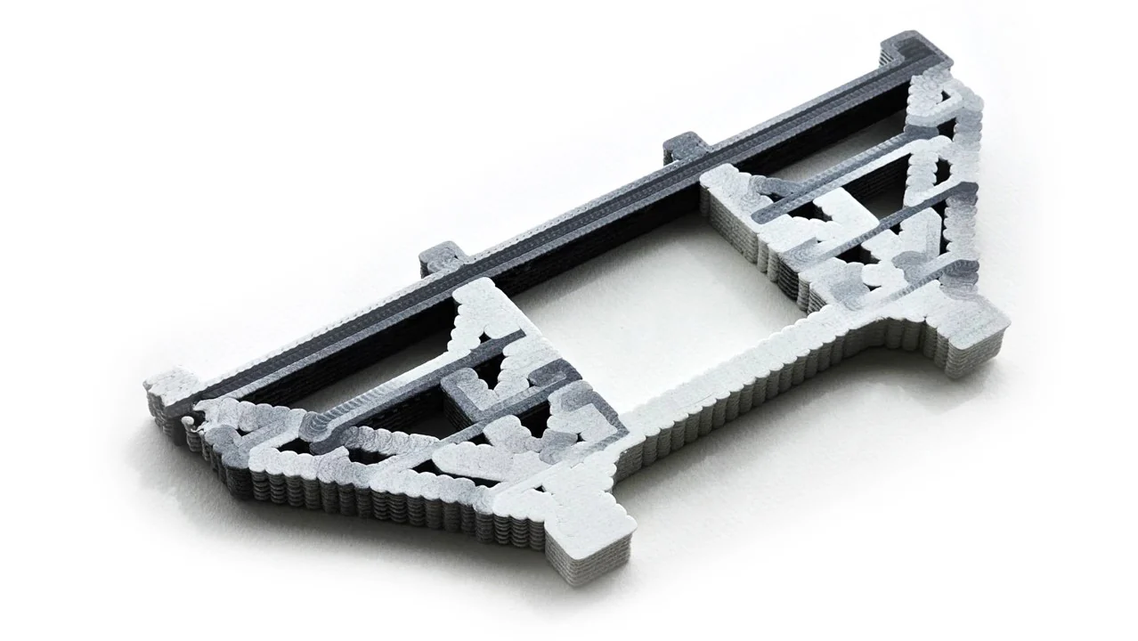 Close view of the printed strut-and-tie object with black tensile regions and white compressive regions