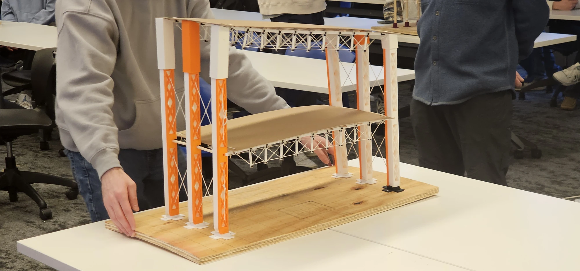 Brooke Kochel, Timotej Murcko, Carmen Martinez-Zamorano, and Olivia Burke — completed two-story truss model with orange and white columns