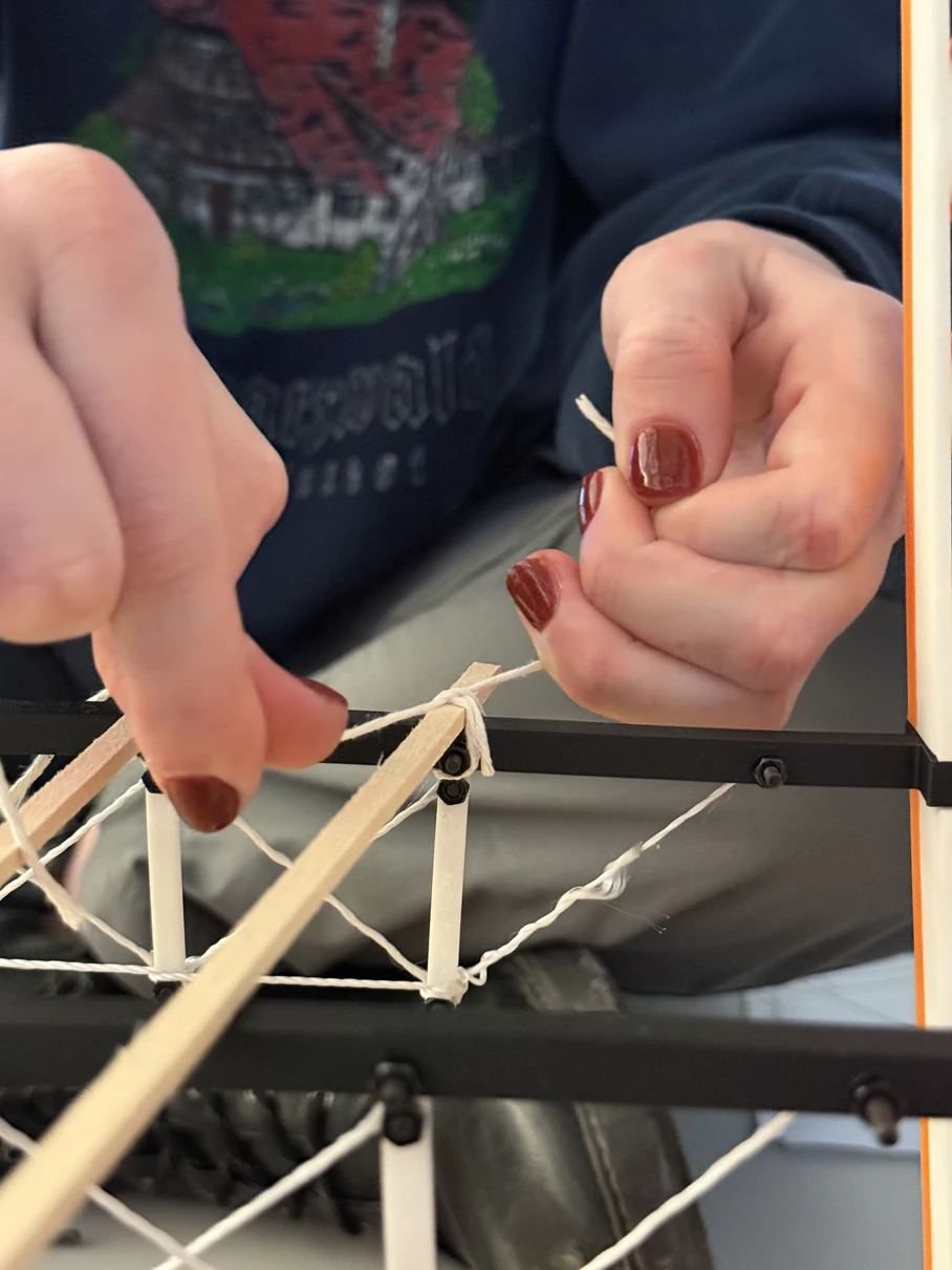 Brooke Kochel, Timotej Murcko, Carmen Martinez-Zamorano, and Olivia Burke — threading and tensioning the truss connections
