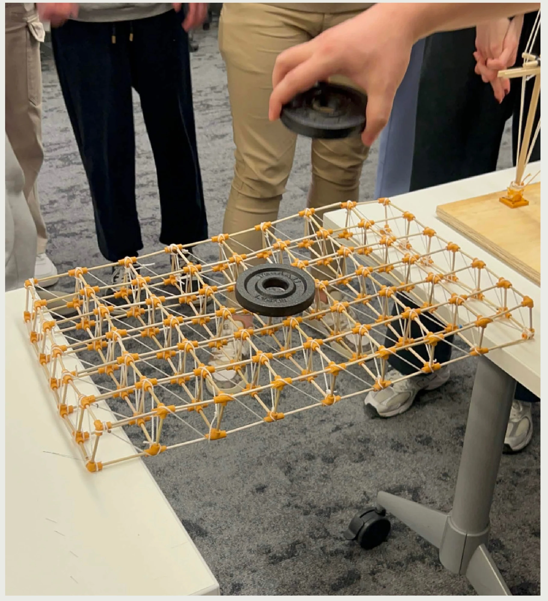 Lucas Guldner, Nick Henderson, Dylan Ries, and Gretchen Ullrich — weight test of the space-truss roof