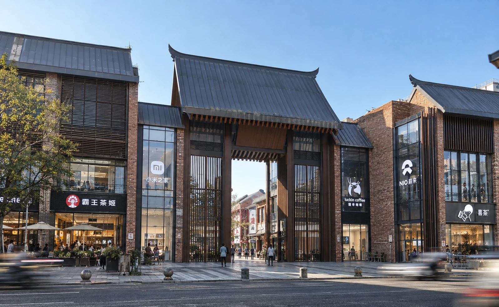 Completed primary gateway framed by brick retail buildings and large pitched roofs