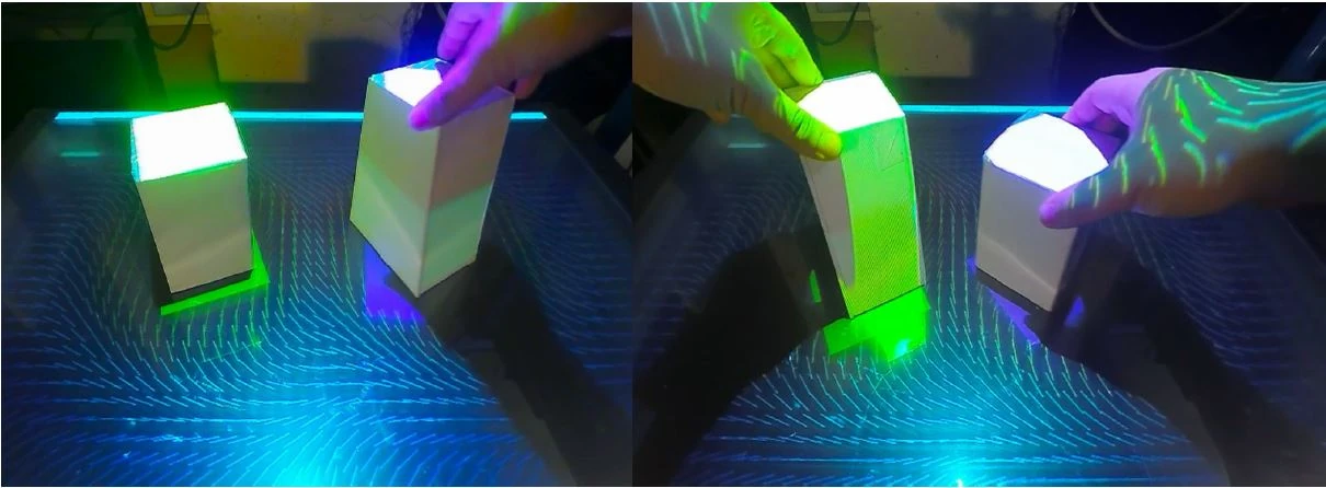 Two tabletop configurations showing projected wind vectors around CuBe building models
