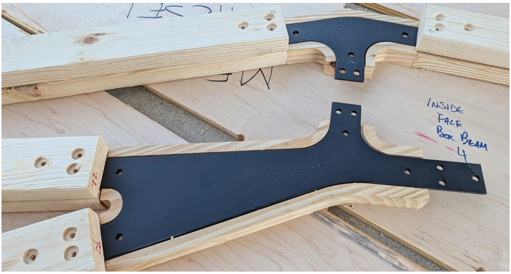 A recessed steel plate connects the timber members within a prefabricated truss.