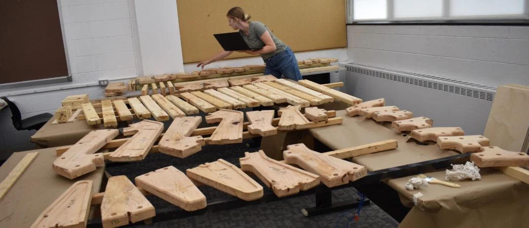 Prepared parts move through shared fabrication and assembly stations.