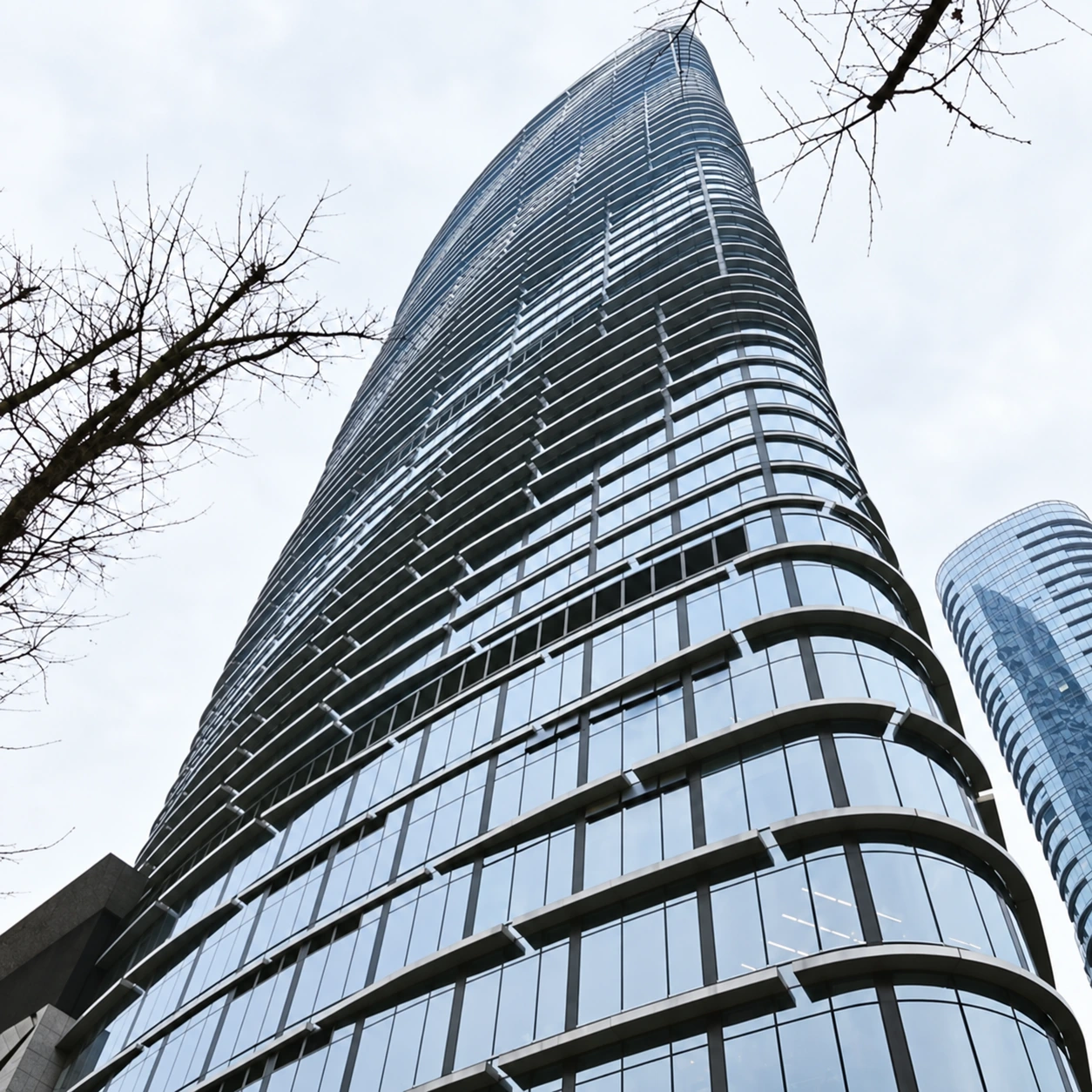 Retouched photograph looking up the curved tower façade