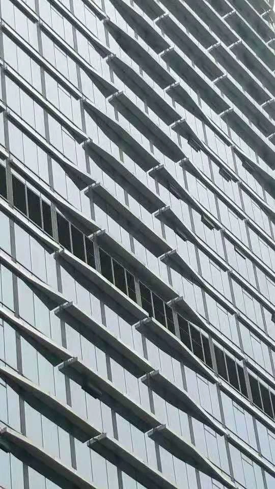 Oblique close-up of horizontal bands along the curved curtain wall