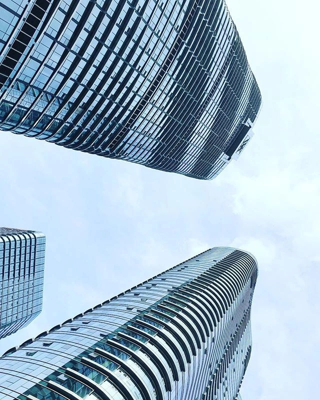 Looking up between two completed glass towers